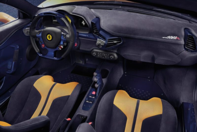 Interior view of a Ferrari 458 Speciale A, featuring a black and yellow color scheme, sporty seats, and a steering wheel with Ferrari logo—showcasing The Last Naturally Aspirated Mid-Engine V8 Ferrari Ever Built.