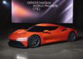 A bright orange Genesis Magma GT Concept sports car is displayed indoors under a large screen reading "GENESIS MAGMA WORLD PREMIERE.