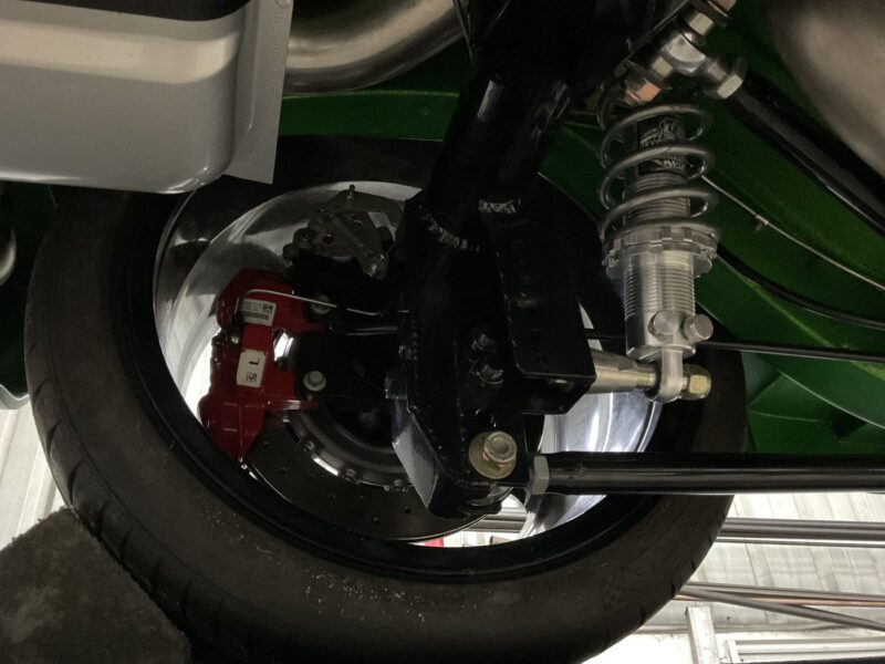 Close-up view of a 1972 AMC Javelin’s suspension system, showcasing the shock absorber, coil spring, disc brake, and caliper—perfect for Pro Touring performance.