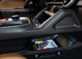 Close-up view of a 2026 Jeep Recon’s center console interior with a smartphone placed in a storage compartment beneath the dashboard, showcasing the trail-ready Jeep’s modern design and convenience.