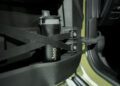 A black Jeep-branded water bottle is secured behind elastic straps in the door compartment of the all-electric, trail-ready 2026 Jeep Recon.