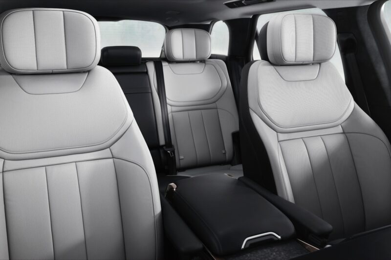 The image shows the interior of a modern car, featuring two front seats and two rear seats with light-colored upholstery and headrests—typical of the refined comfort found in the 2025 Land Rover Range Rover Sport Dynamic SE PHEV.