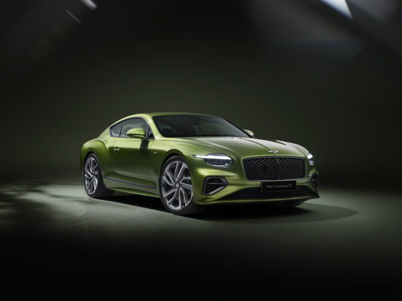 A green Bentley Continental GT coupe is showcased in a studio, dramatic lighting accentuating its curves—a perfect backdrop for a review of the 2026 Bentley Continental GT Speed.