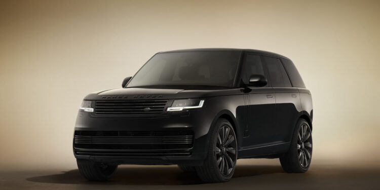 A SV Black Range Rover SUV is parked indoors on a neutral, softly-lit background, viewed from the front left corner.