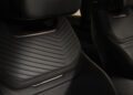 Close-up view of two black leather car seats with a chevron pattern and metallic accents, showcasing SV Luxury Features inspired by Range Rover design.