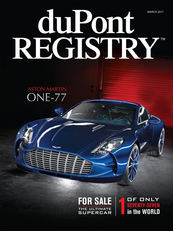 Cover Cars: duPont REGISTRY’s 40th Anniversary issue showcases a blue Aston Martin One-77 supercar in front of a red garage, highlighting its rarity and sale status.