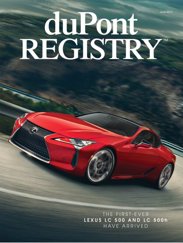 A red Lexus LC 500 sports car drives on a winding road, featured as one of the Cover Cars in the duPont REGISTRY magazine's June 2017 issue.