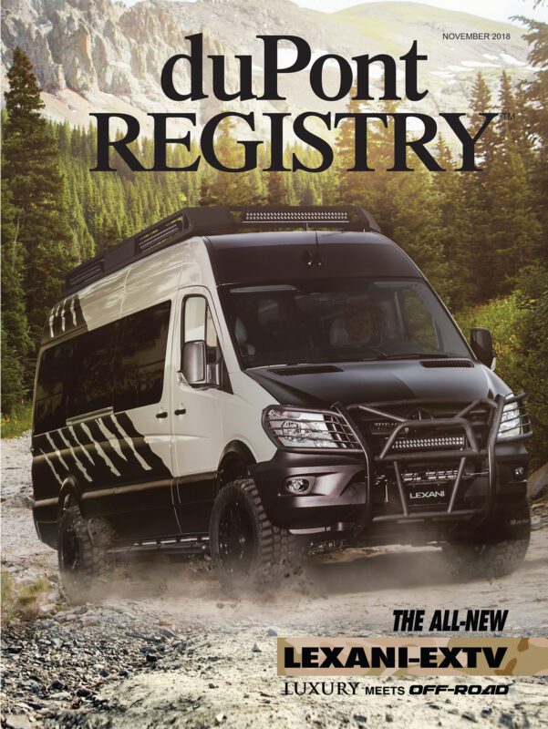 A luxury off-road van is parked on a rocky path in a forest, featured as one of the Cover Cars on the duPont REGISTRY magazine’s November 2018 issue.