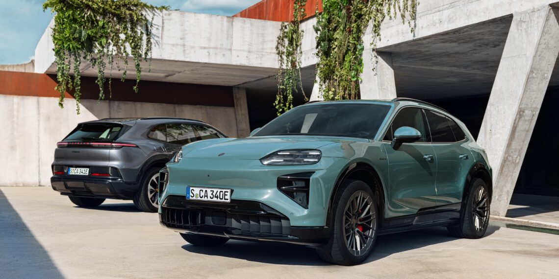Two modern electric SUVs, including The Most Powerful Production Porsche Ever: 2026 Cayenne Electric, are parked outside a concrete building with plants hanging from above; both vehicles have European license plates.