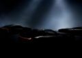 Three sleek, dark Lexus sports cars are partially illuminated under spotlights, with red accent lights on their rear sections visible through the darkness—hinting at a reveal on December 5th.