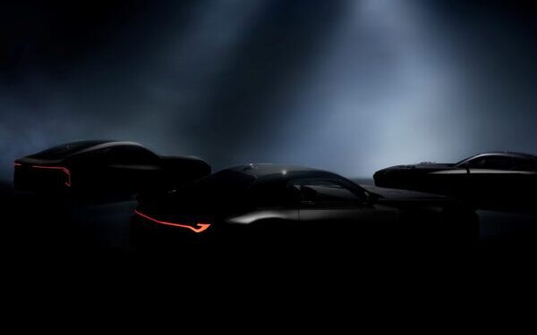 Three sleek, dark Lexus sports cars are partially illuminated under spotlights, with red accent lights on their rear sections visible through the darkness—hinting at a reveal on December 5th.