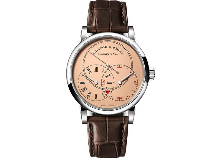 Featured in the duPont REGISTRY 2026 Holiday Gift Guide, this luxury wristwatch boasts a pink dial, Roman numerals, subdials, and a brown leather strap, branded “A. Lange & Söhne Glashütte I/SA.”.