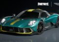 A teal Aston Martin sports car with yellow racing stripes is displayed on a dark background, featuring the Fortnite and Aston Martin logos above.