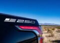Close-up of the rear badge and tail light of a Chevrolet pickup truck, with a desert landscape and blue sky in the background, celebrating Chevy Honors America’s 250th Anniversary With Ultra-Exclusive Stars & Steel Collection.