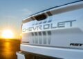 Close-up of the rear of a white Chevrolet Silverado RST truck at sunset, showcasing the Chevrolet logo and emblem. This model is part of the ultra-exclusive Stars & Steel Collection as Chevy honors America’s 250th anniversary.