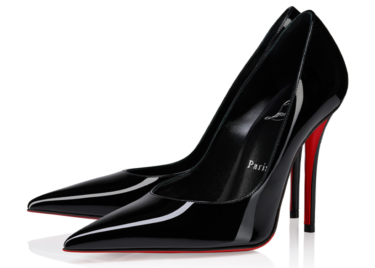 A pair of black patent leather high-heeled pumps with pointed toes and red soles, positioned side by side on a white background—perfect for the 2026 duPont REGISTRY Holiday Gift Guide.