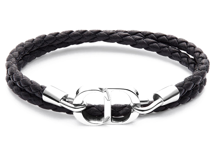 A double strand black braided leather bracelet with a polished silver-toned clasp in the center, featured in the duPont REGISTRY 2026 Holiday Gift Guide.