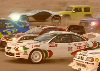 Multiple rally cars, including a Toyota Castrol, race closely on a dirt track with dust in the air, capturing the excitement of Gran Turismo 7. Other cars and a yellow SUV are visible in the background.
