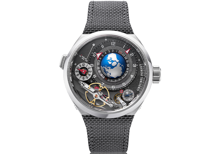 Featured in the duPont REGISTRY's 2026 Holiday Gift Guide, this luxury wristwatch boasts a textured black strap, silver case, exposed gears, and a striking blue-and-white globe at the center of the dial.