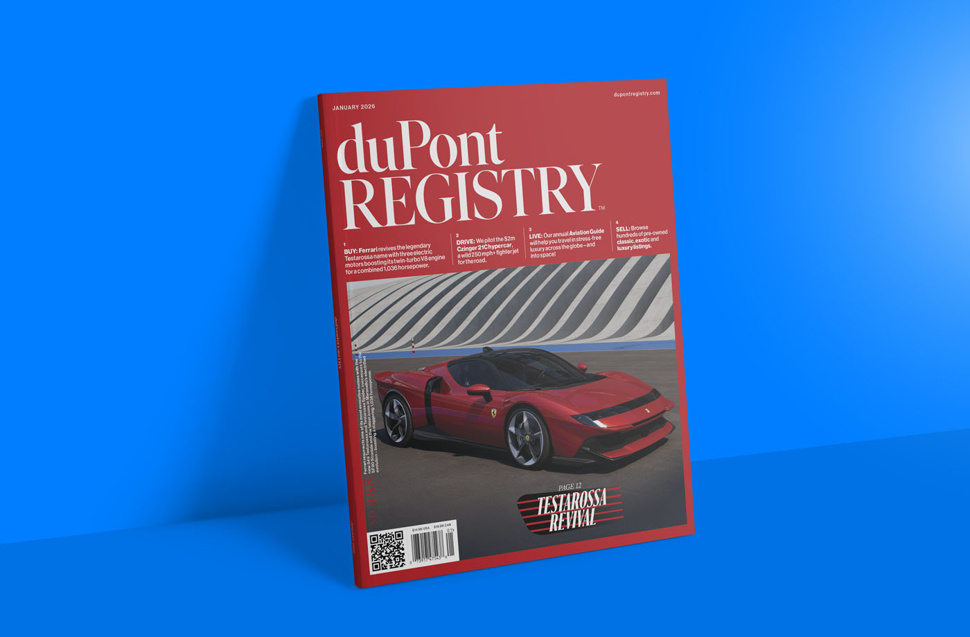 A January 2026 duPont REGISTRY magazine with a red cover featuring a red Ferrari Testarossa Revival car against a striped background, displayed upright on a blue surface.