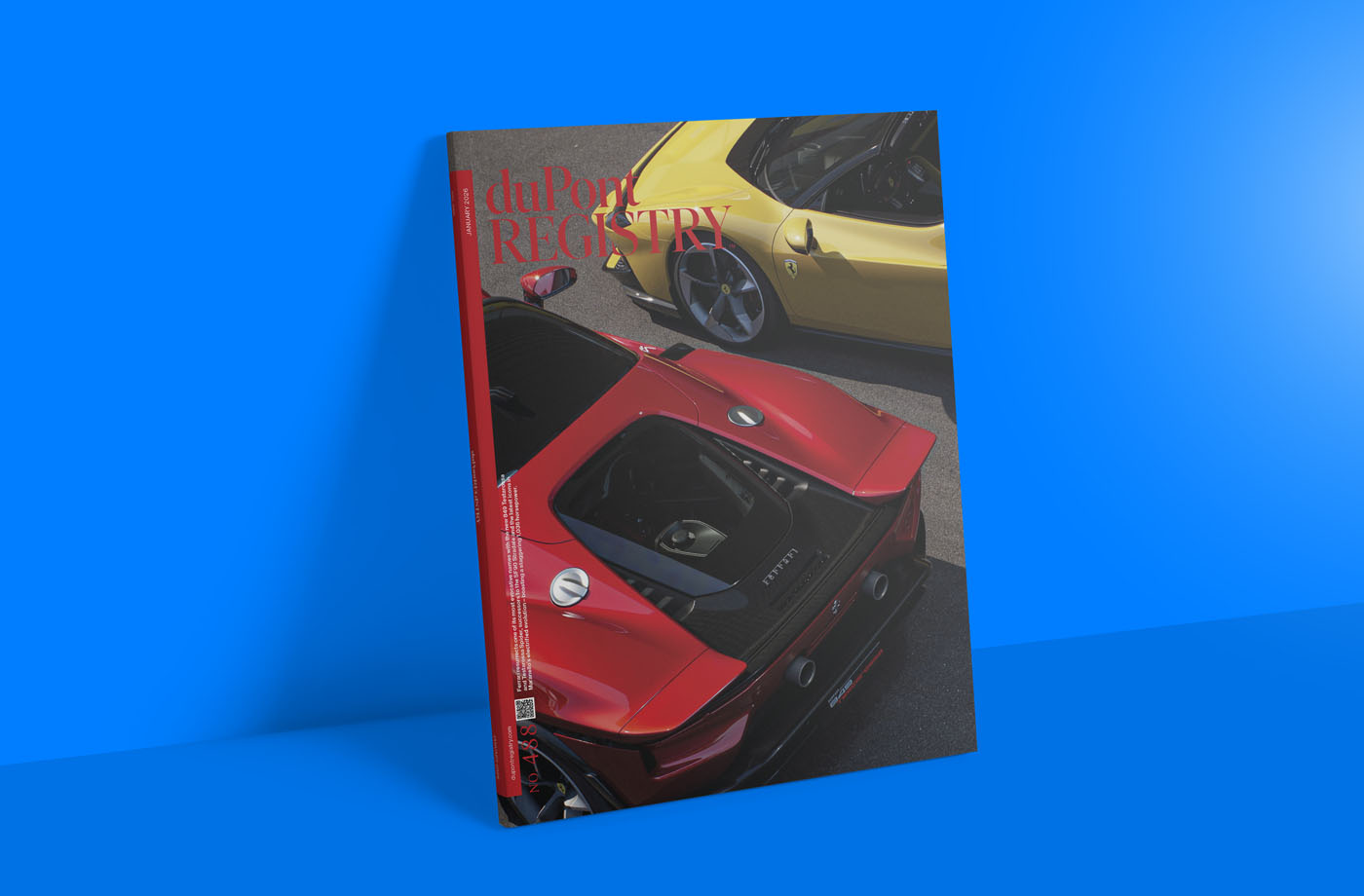 A January 2026 issue of duPont REGISTRY magazine featuring red and yellow sports cars on the cover, placed upright against a blue background.
