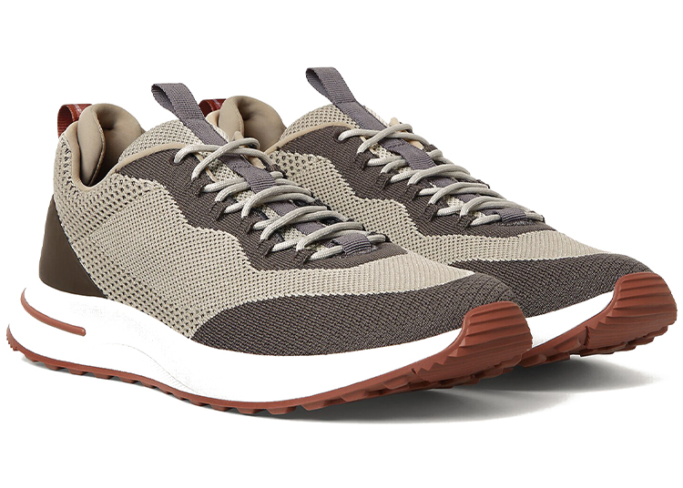 A pair of beige and brown athletic sneakers with white midsoles and brown rubber outsoles, featured in the duPont REGISTRY 2026 Holiday Gift Guide, shown on a white background.