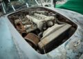 Rusty and deteriorated engine exposed in the hood of an old, weathered classic car, with peeling paint and corroded metal parts—this rare DB5 holds an incredible story beneath its worn exterior.