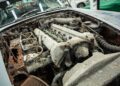 A heavily rusted and corroded Aston Martin DB5 engine with visible damage and debris in the engine bay, once a prized example from Aston Martin Works.