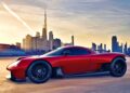 A red sports car is parked on an open surface, modern city skyline and skyscrapers glowing at sunset—a scene echoing Oilstainlab’s Rebellion Against Mediocrity and the spirit behind Feature Exclusive: Inside the Minds Behind the HF-11.