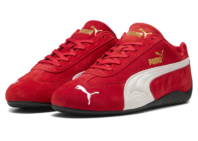 A pair of red Puma sneakers with white side stripes, gold Puma logos, and black soles displayed against a white background—a stylish pick for the 2026 Holiday Gift Guide by duPont REGISTRY.