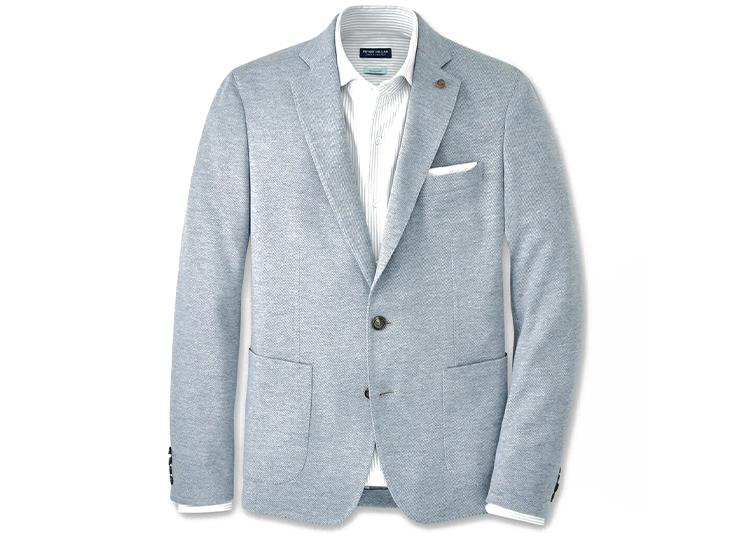 Light gray men's blazer with two front pockets, a white pocket square, two buttons, and a white collared shirt underneath, featured in the duPont REGISTRY Holiday Gift Guide 2026. Displayed on a white background.
