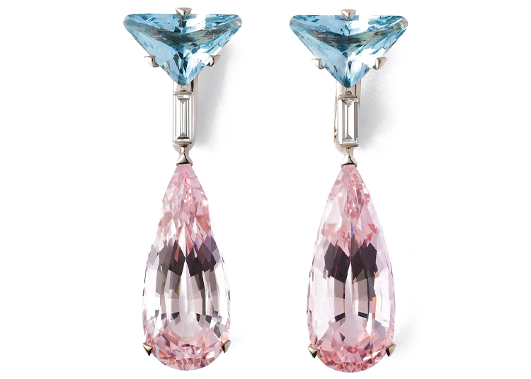 A pair of drop earrings featured in the duPont REGISTRY 2026 Holiday Gift Guide, showcasing blue triangular gemstones at the top, rectangular connectors, and large pink teardrop-shaped gemstones hanging below.