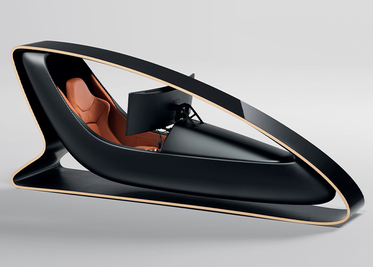 A modern, black, enclosed workstation with a brown leather seat and a mounted monitor, featured in the duPont REGISTRY Holiday Gift Guide, boasts a sleek, curved outer shell set against a plain background.