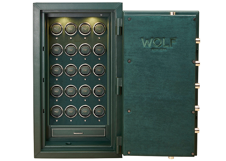 A green WOLF brand safe with its door open, featured in the duPont REGISTRY Holiday Gift Guide 2026, reveals multiple circular compartments arranged in rows inside, each labeled with the WOLF logo.
