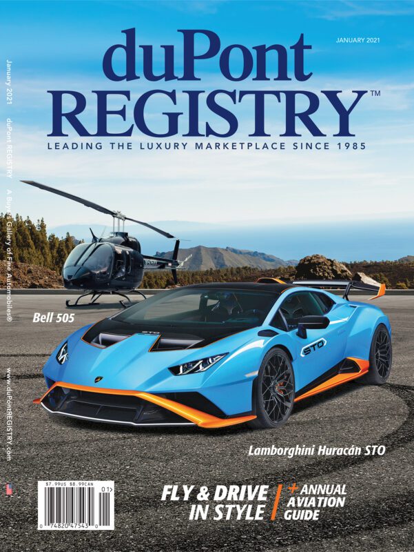 A blue and orange Lamborghini Huracán STO and a Bell 505 helicopter star as the Cover Cars on the January 2021 duPont REGISTRY magazine, celebrating the 40th Anniversary of this iconic automotive publication.