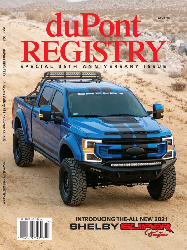 A blue 2021 Shelby Super Baja truck parked on sandy terrain, featured as one of the Cover Cars for the 40th Anniversary issue of duPont REGISTRY’s April 2021 magazine.