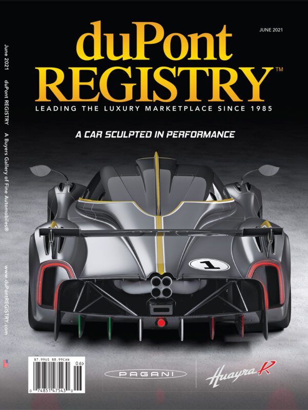 Rear view of a black Pagani Huayra R sports car on the duPont REGISTRY Cover Cars issue, June 2021, celebrating the 40th Anniversary, with the headline “A car sculpted in performance.”.