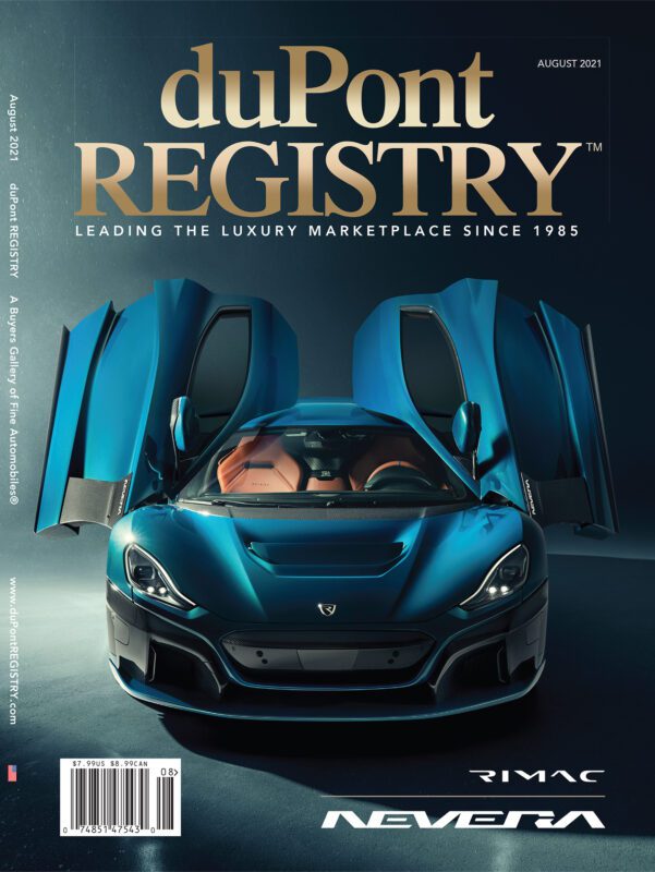 A blue Rimac Nevera electric hypercar with gullwing doors open is featured as one of the Cover Cars on the August 2021 duPont REGISTRY magazine, celebrating its 40th Anniversary.