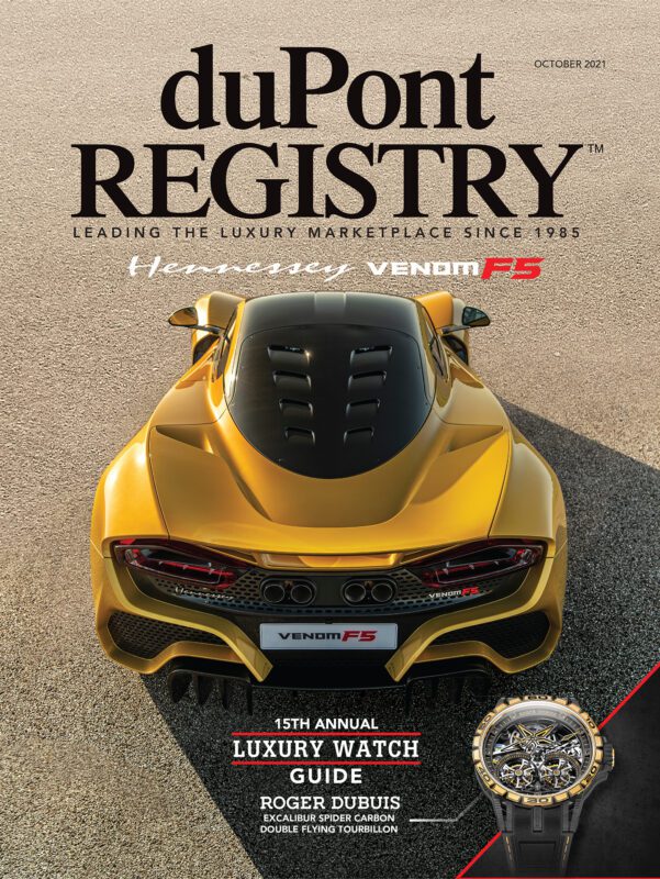 A yellow Hennessey Venom F5 sports car is shown from above on the 40th Anniversary cover of duPont REGISTRY magazine, October 2021, featuring a luxury watch guide.