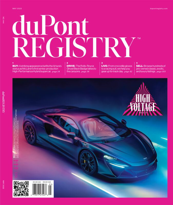 A sleek silver-blue McLaren Artura sports car is displayed under dramatic lighting on the duPont REGISTRY Cover Cars issue, celebrating the magazine’s 40th Anniversary in May 2022.