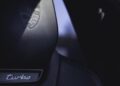Close-up of a Porsche Macan Electric car seat headrest featuring the embossed Porsche crest and a "turbo" badge below, perfect for your Road to Christmas adventure.