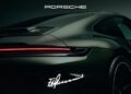 Rear view of a dark green Porsche 911 GT3 with illuminated red tail light, Porsche logo above, and a white F. A. Porsche signature near the bottom, commemorating his 90th birthday.