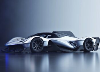 The production version of the Red Bull RB17 hypercar is revealed: a futuristic, silver machine with aerodynamic curves and black accents, parked on a reflective surface against a gradient background.